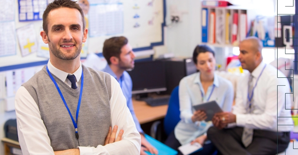 The office workers with one person standing in front and the rest of the team sitting behind him