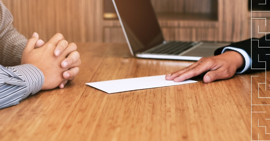 2 colleagues hands next to the office desk with the peace of paper